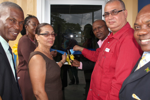 Minister without portfolio in the Ministry of Transport, Works and Housing, Dr. Morais Guy (3rd right), cuts the ribbon to reopen the Island Traffic Authority St. Ann’s Bay Examination Depot Others at the opening are: Minister of State in that Ministry,. Richard Azan (2nd right); Councillor for the St. Ann’s Bay Division, Dalas Dickenson (left); Member of Parliament for North East St. Ann, Shahine Robinson (2nd left); Custos of St. Ann, Norma Walters (3rd left), and Mayor of St. Ann’s Bay, Councillor Desmond Gilmore. Dr Guy who spoke at the opening  said the Port Maria Depot will be refurbished soon and that all depots will be fitted with closed circuit television. (JIS Photos) 