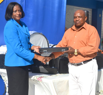 MUSICAL: Principal of Steer Town Academy, St Ann, Marcia Grant (left) receives one of several musical instruments presented to the school by Mayor of St Ann’s Bay, Desmond Gilmore on Tuesday, February 4. 