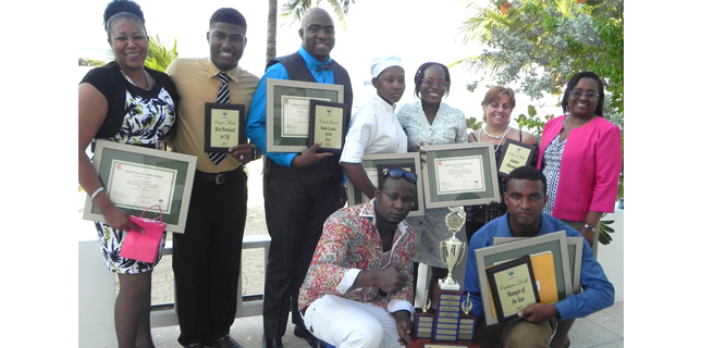 Maxine Stewart (front row- eighth from left), human resources manager at Couples Tower Isle poses with some of the awardees; (first row-from left) Icco Harris, Royan Marsh, Errol Sewell, Alecia Brown, Keneisha Robinson and Pollyanna Haber. Also sharing in the moment is (stooping –from left) Rohan Samuels and Carlinton Dodd. 