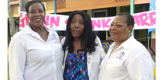 Cancer survivor, Jody Wilson-Hinds (centre) flanked by administrative assistant of the St Ann/St Mary branch of the Jamaica Cancer Society, Minna Walters and branch manager, Marilyn Williams (right).