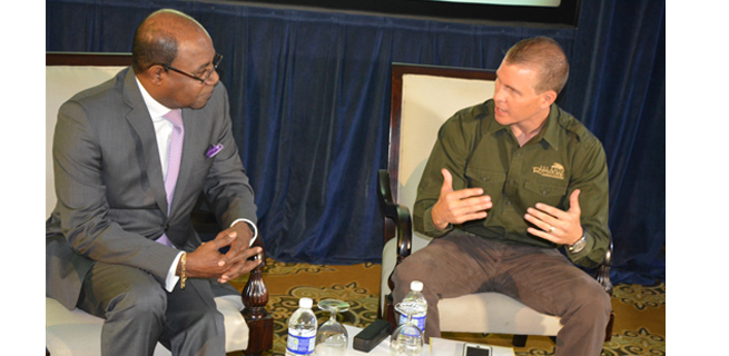 Minister of Tourism, Edmund Bartlett (left) in discussion with chief executive officer of Island Routes Caribbean Adventures, Adam Stewart (right). 